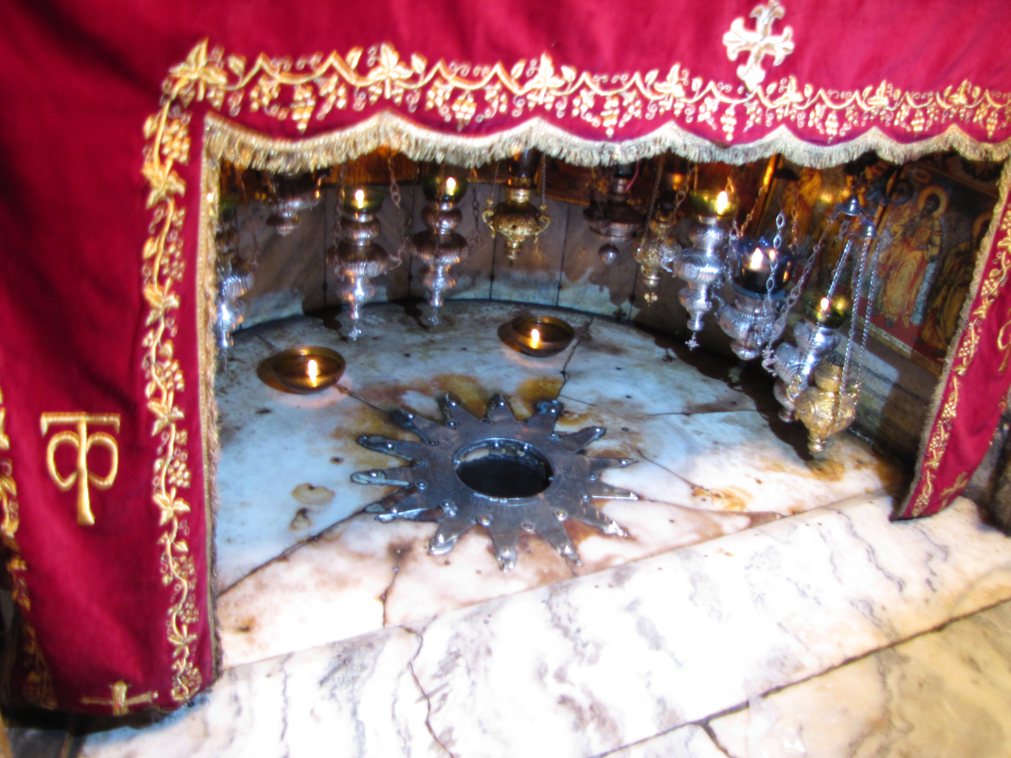 Silver star and shrine over the oringal stone floor of the cave where Jesus was born